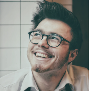 smiling young man with glasses