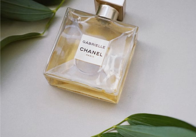 a bottle of chanel perfume on a wooden desk