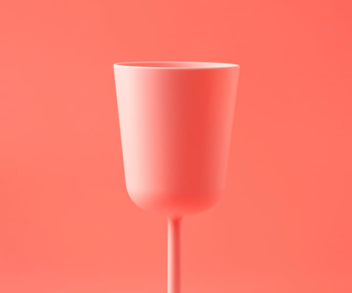 tall pink glass on a pink background